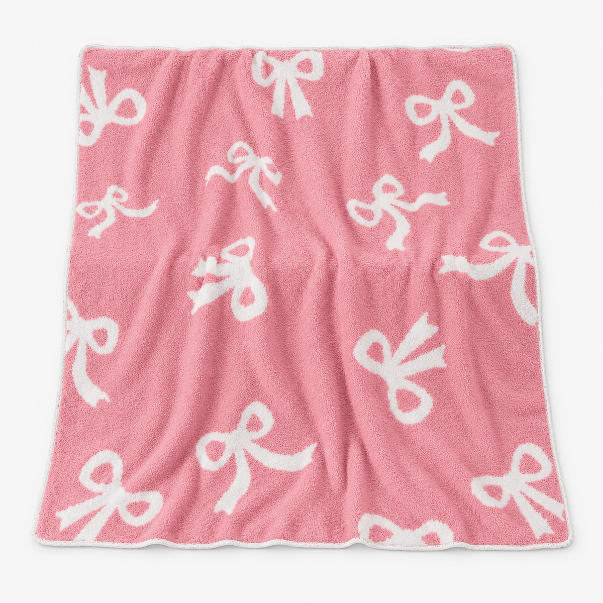 Lirevan bow fleece throw blanket in pink with white bows laid fully open on a white background