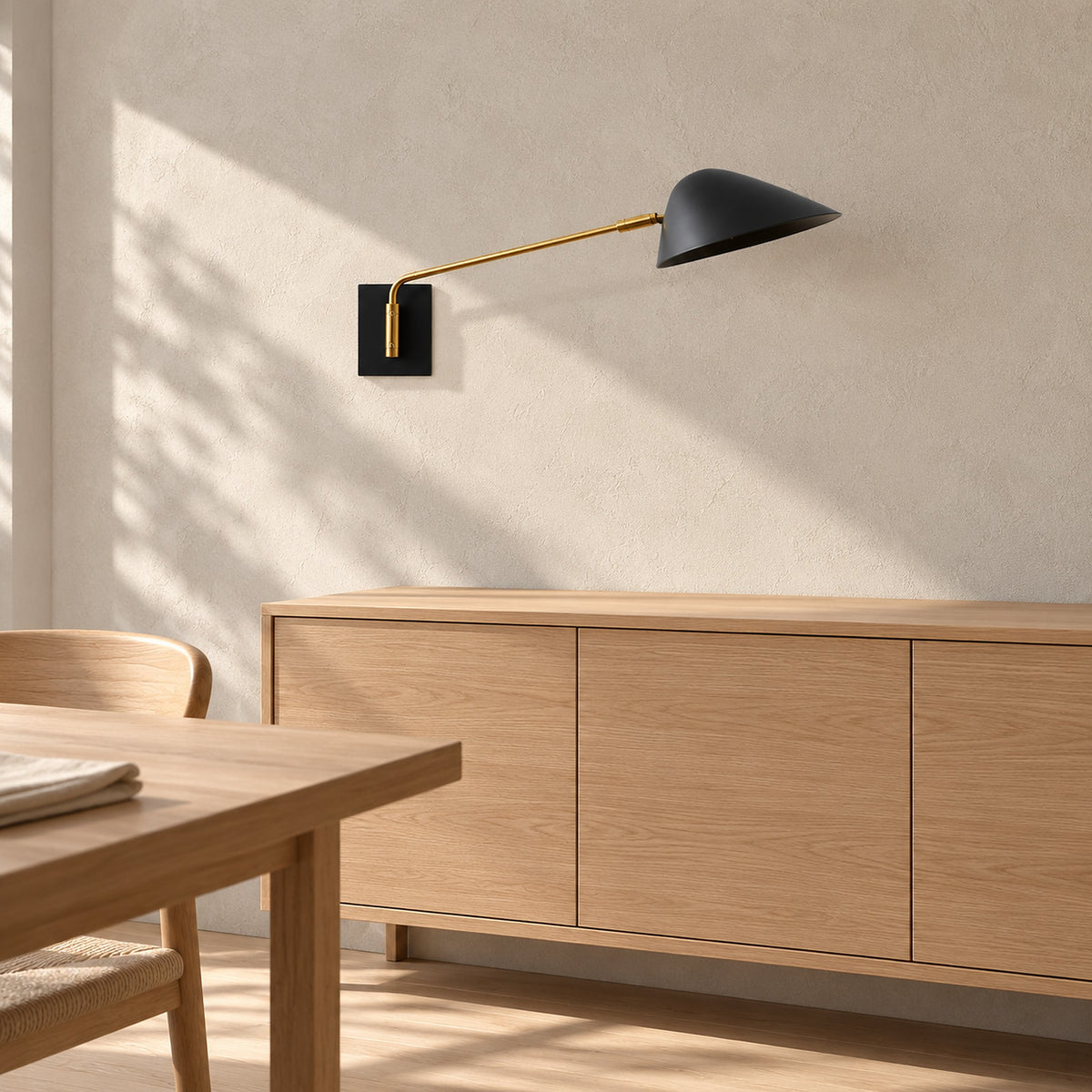 Lirmena black hardwired wall sconce unlit above a sideboard in a bright dining room