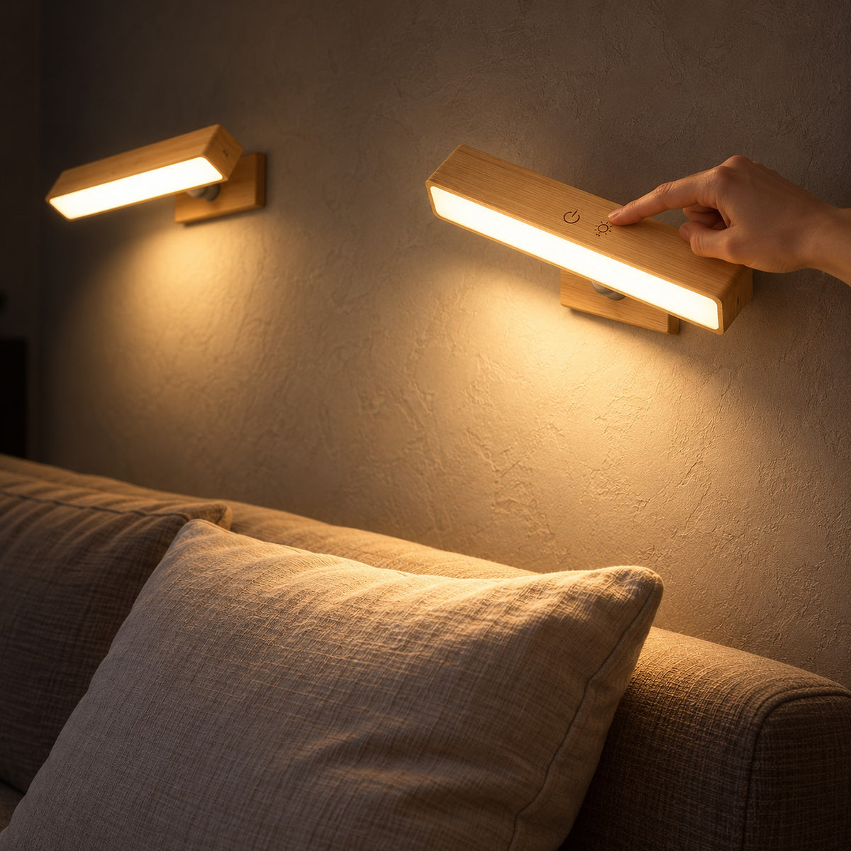 Lisomar main wall lamp pair angled above a sofa corner in a living room at night
