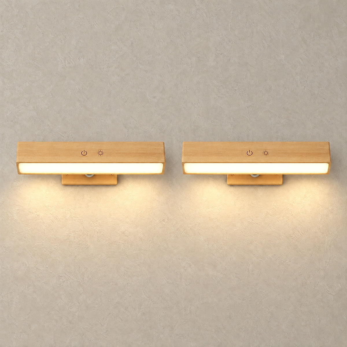 Lisomar main wall sconce pair lit up, casting pools of light across a plain plaster wall