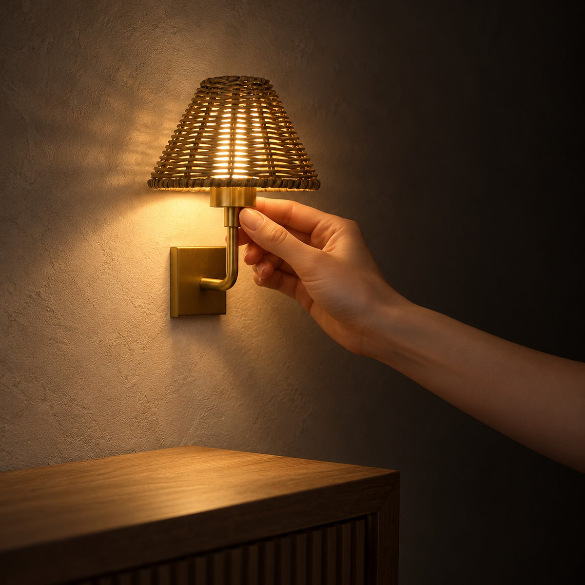 Lomarvi gold wall light casting soft warm light across an entryway wall at night