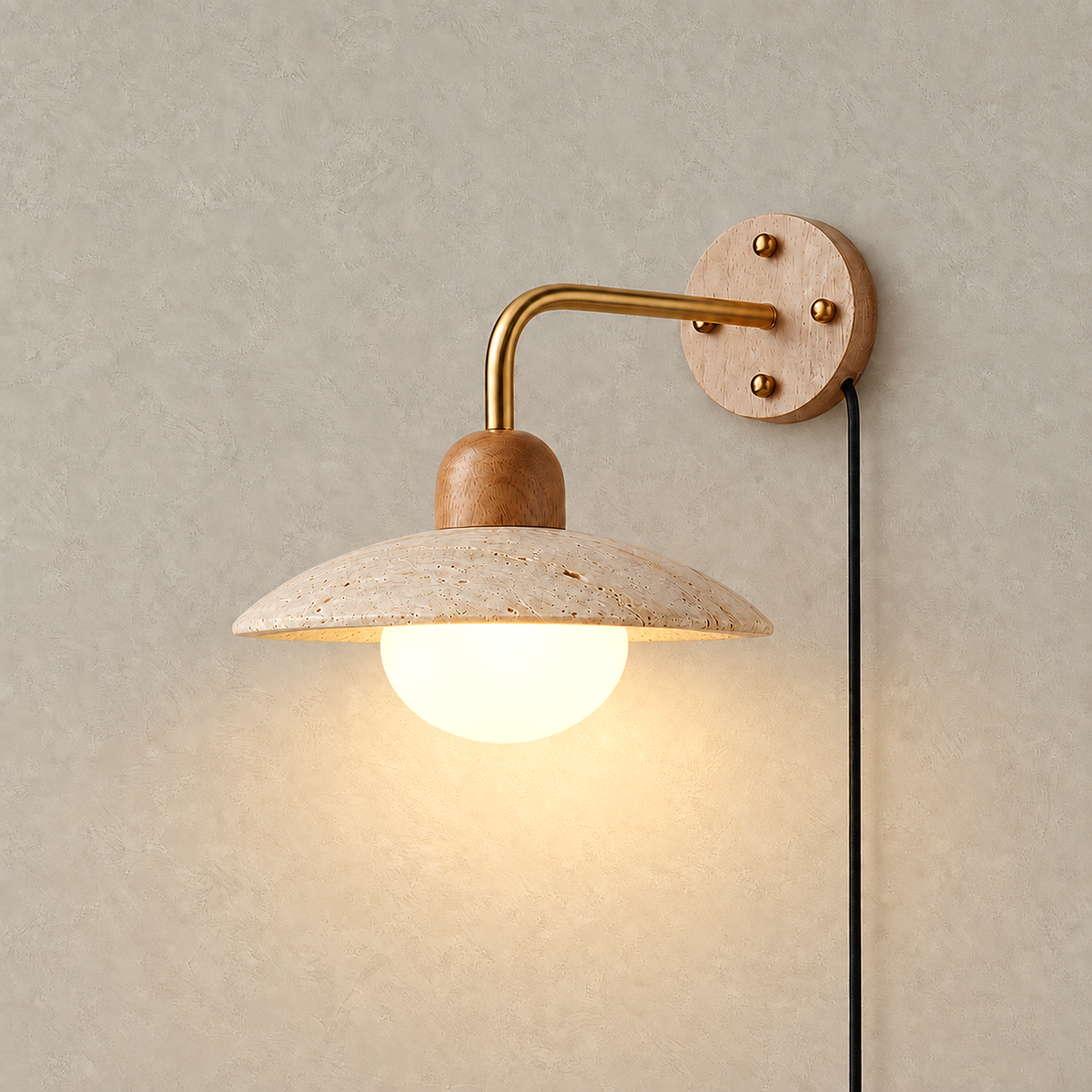 Lomiseta gold and yellow travertine wall sconce glowing against warm greige plaster