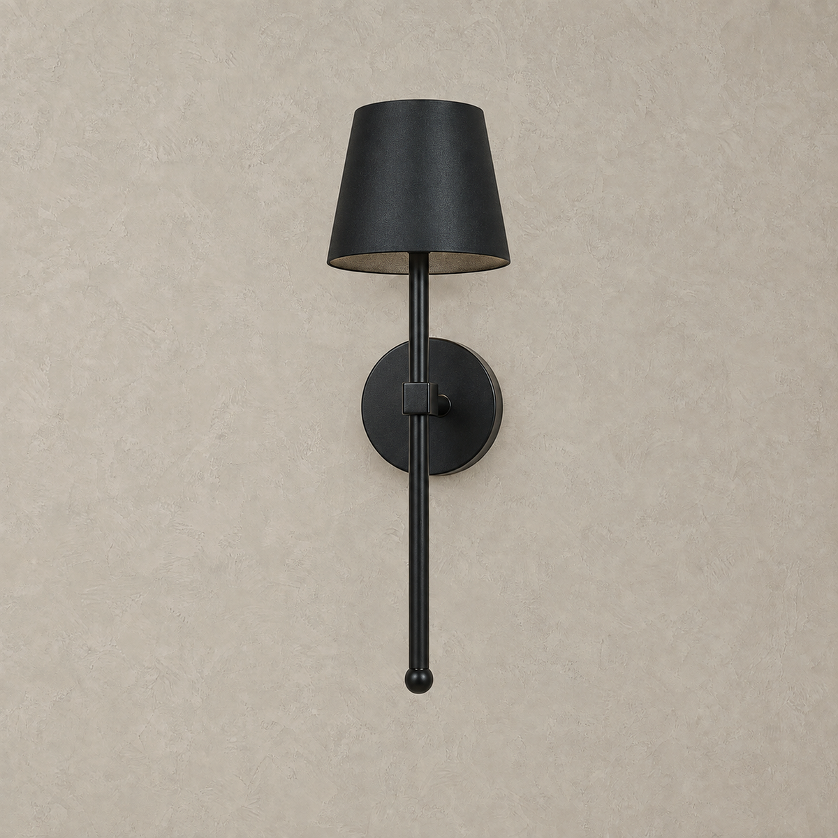 Loranno black LED wall sconce unlit against a warm greige plaster wall