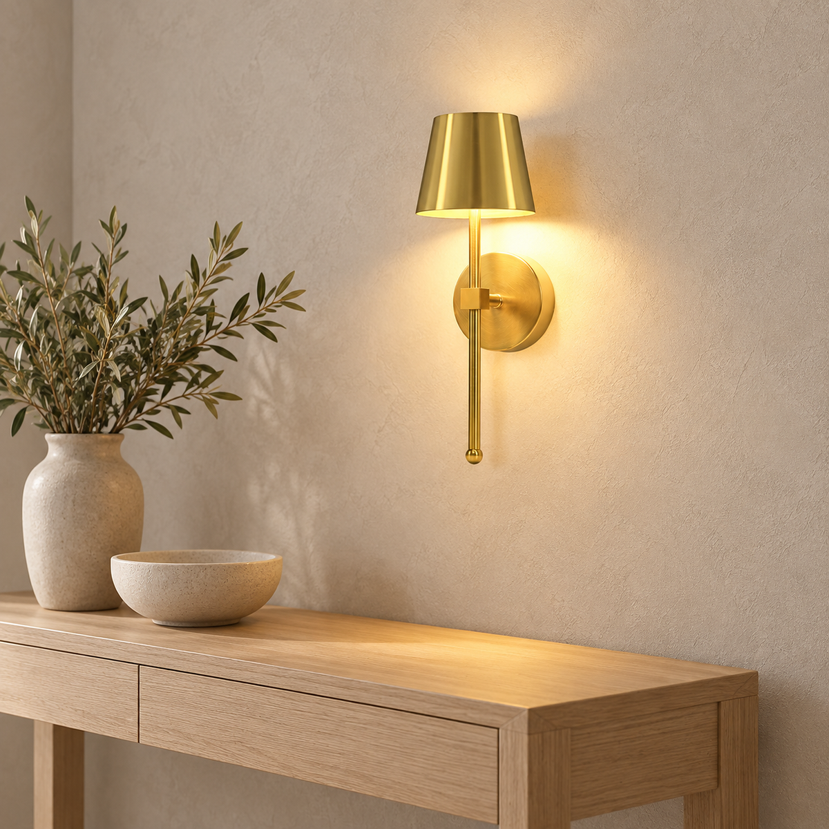 Loranno gold battery operated wall sconce glowing above an entry console in daylight #color_gold