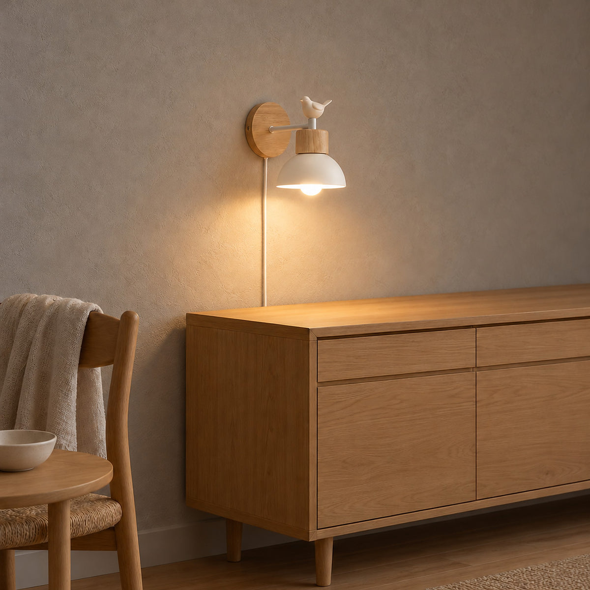 Lorsenta white wall lamp mounted above a dining room sideboard so the bird and light share one spot on the wall