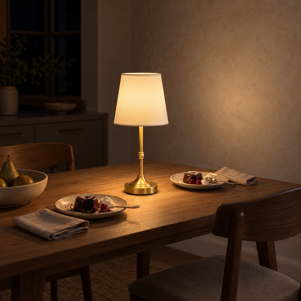 Lorvesa gold cordless table lamp glowing softly beside dessert dishes after dinner