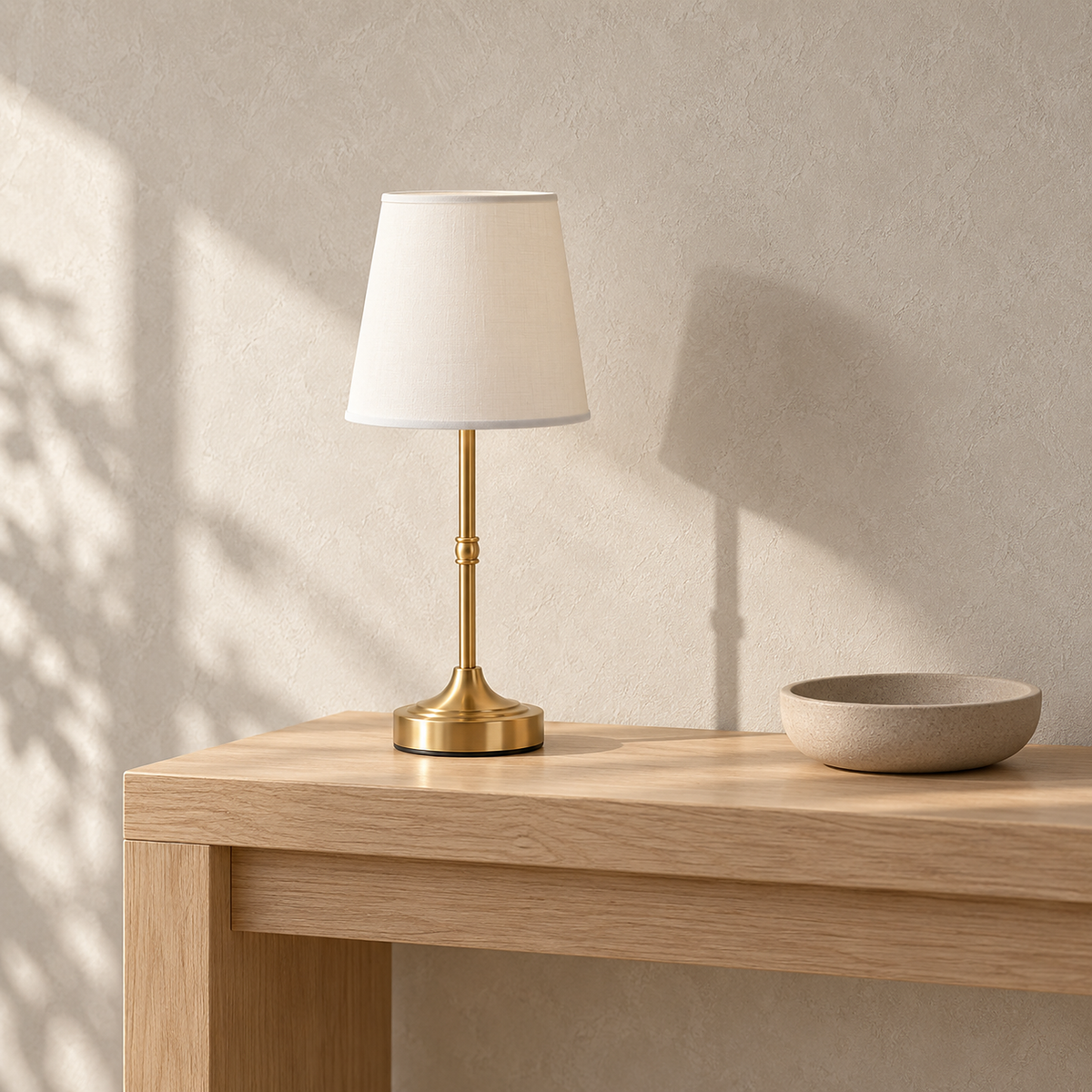 Lorvesa gold table lamp standing unlit on a sunlit entryway console