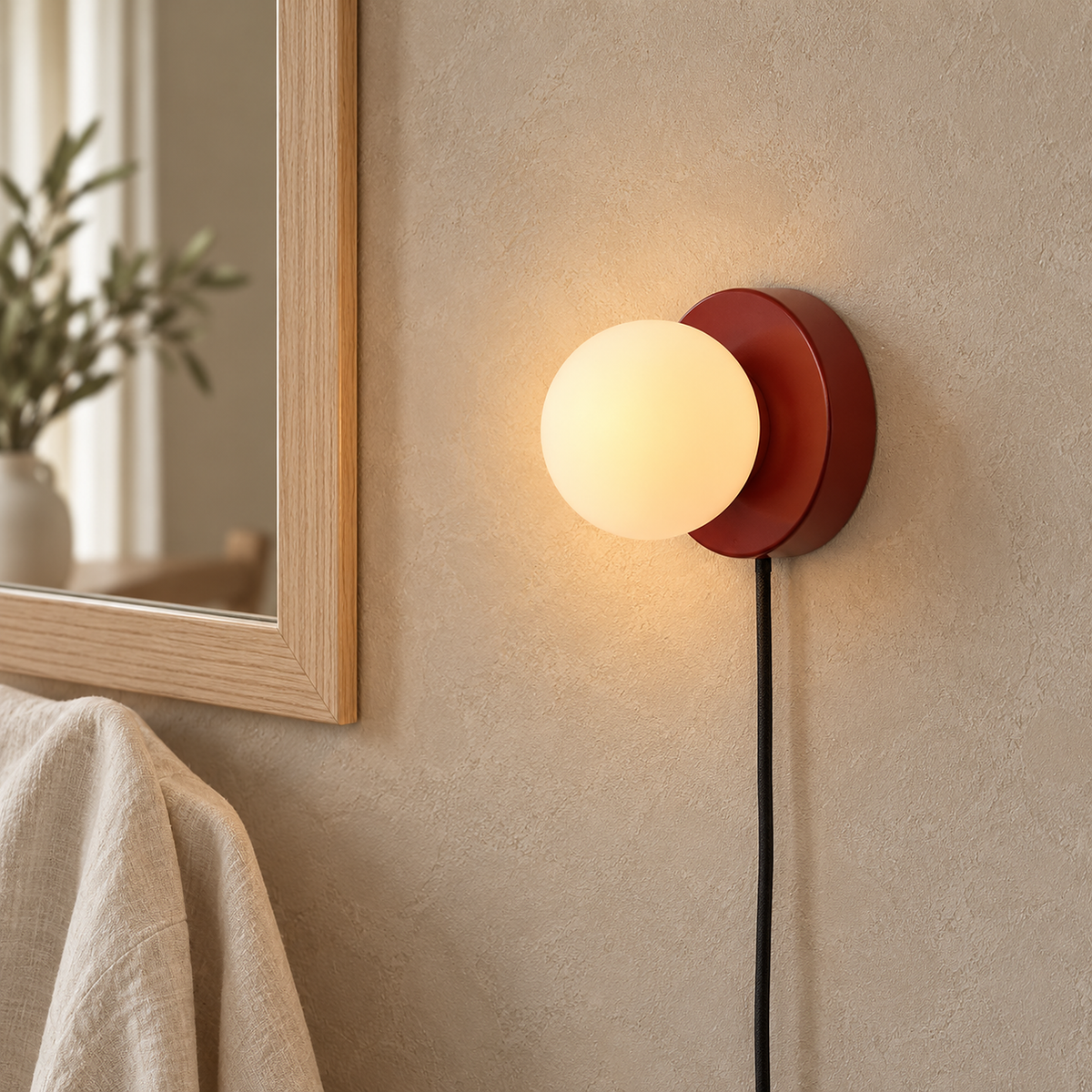 Memilora red plug in wall light glowing beside a dressing room mirror #color_red