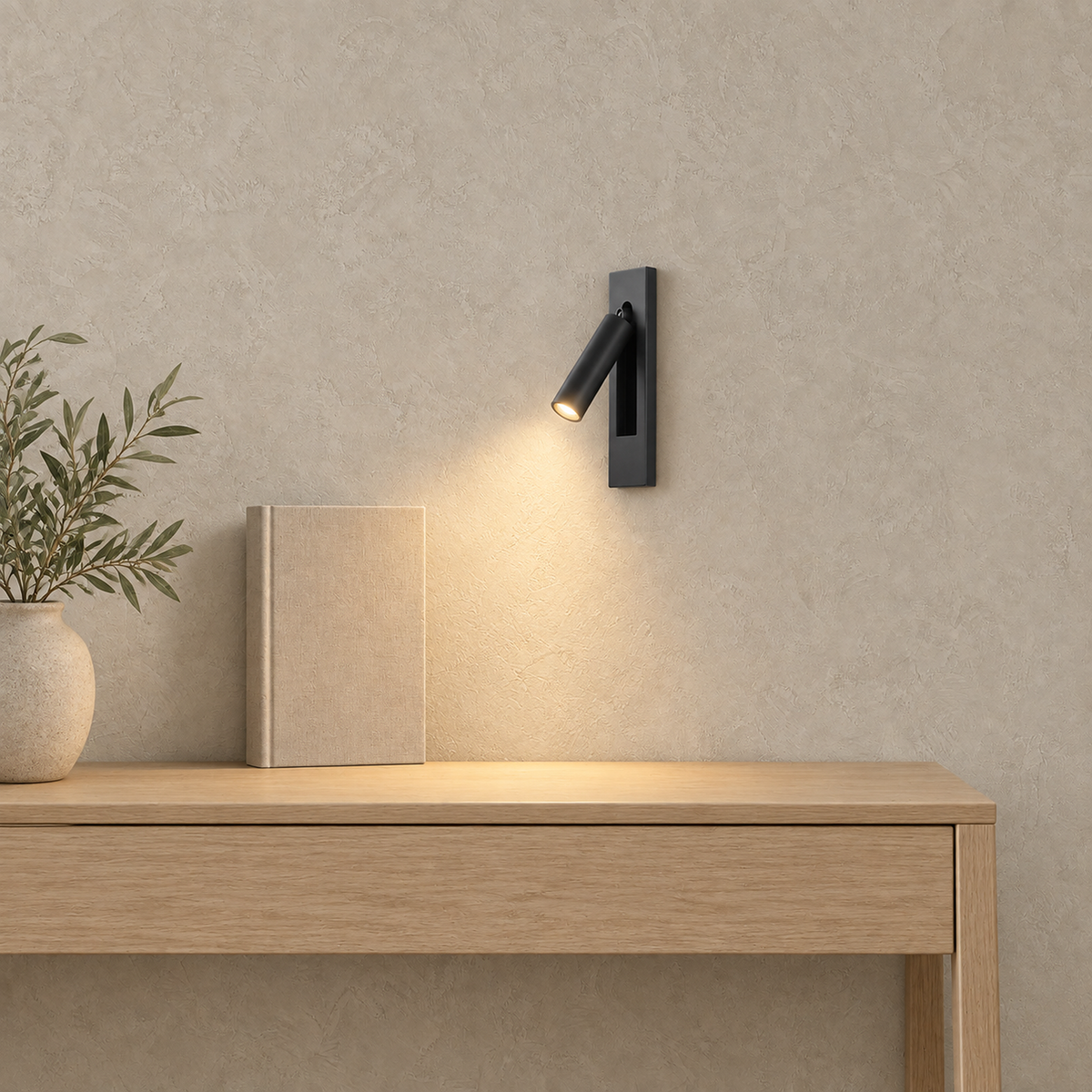 Menaliro black wall sconce lit above a writing console in a sunlit home office