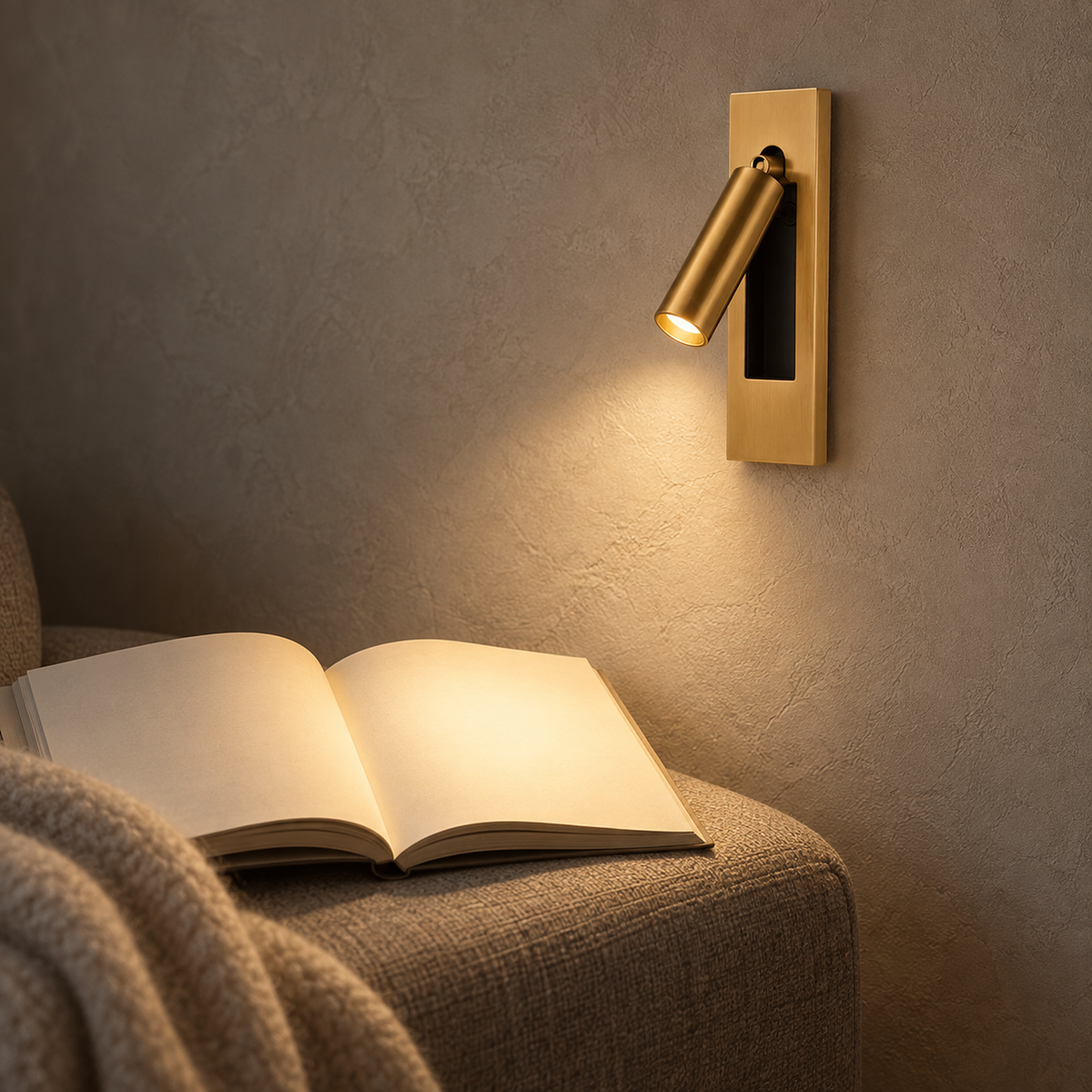 Menaliro gold LED wall sconce illuminating an open book in a library reading alcove #color_gold