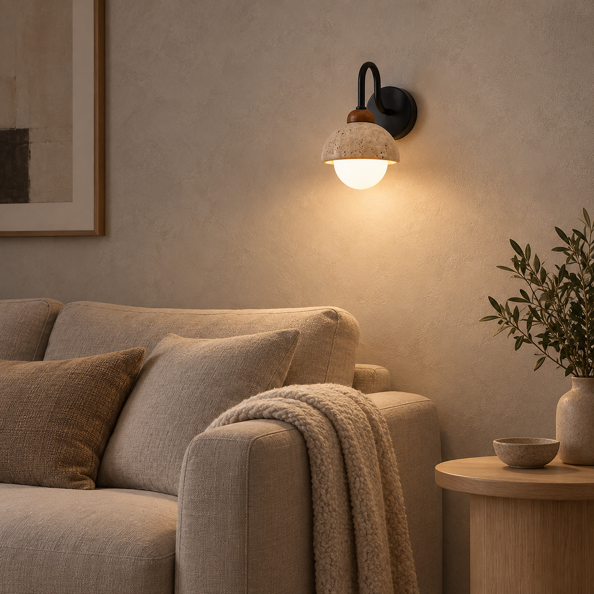 Meratilo yellow travertine and black LED wall sconce glowing with white globe above an oatmeal sofa