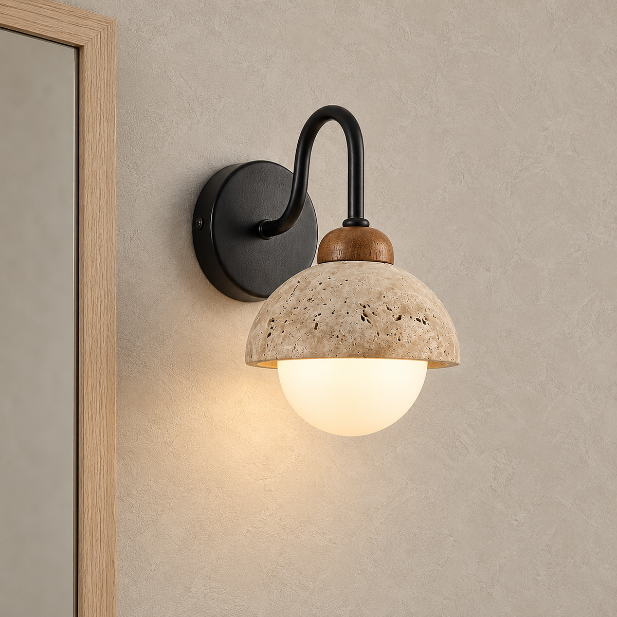 Meratilo yellow travertine and black wall sconce lit beside an entryway mirror edge by day
