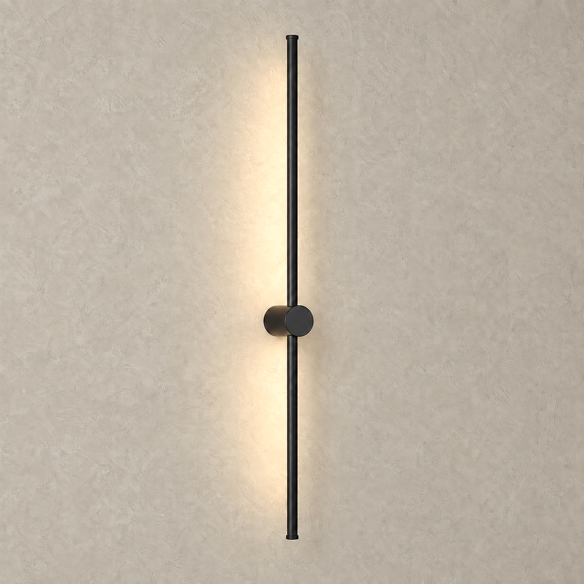 Merisano black LED wall sconce casting a warm vertical glow from its slim lit rod