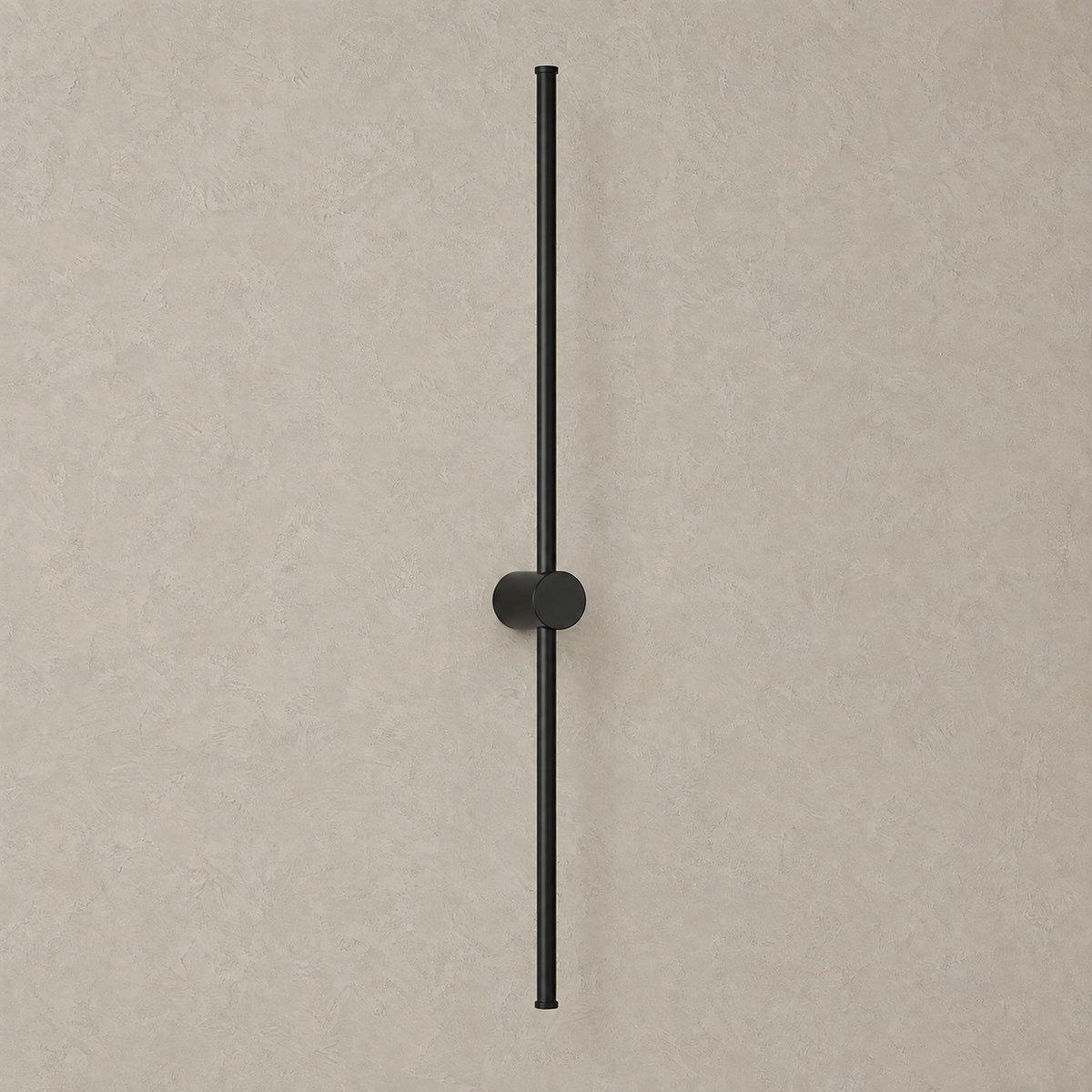 Merisano black rechargeable wall sconce unlit on a greige plaster wall, slim rod on a round base