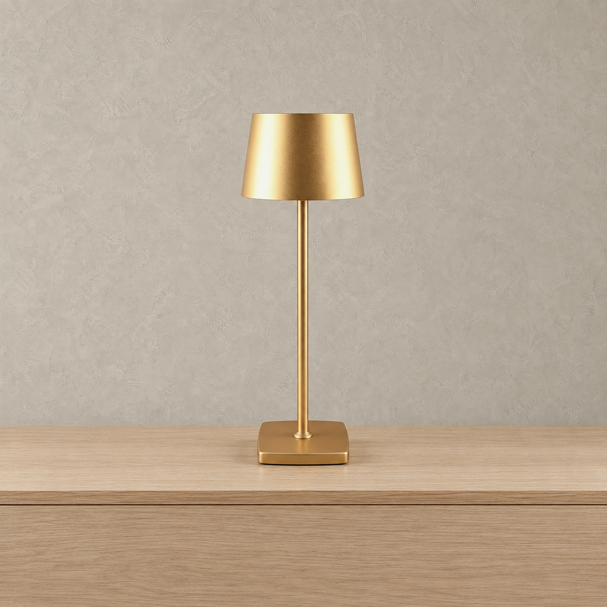 Mevolani rechargeable table lamp in gold with a low profile rounded square base shown switched off