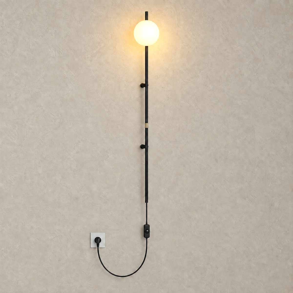 Milorsa black plug in led wall sconce lit on a plain plate with its frosted glass ball shade glowing