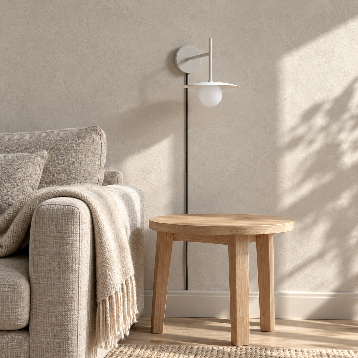 Milvaro white plug in wall sconce switched off above an empty den side table in daylight