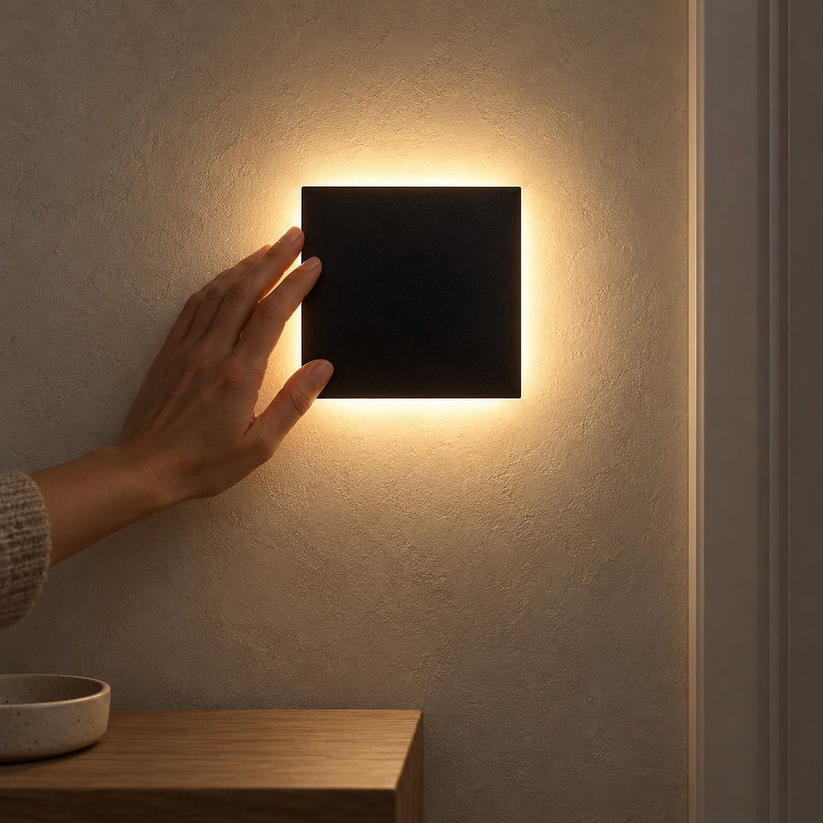 Mivorel black battery operated wall sconce lit on narrow hallway plaster