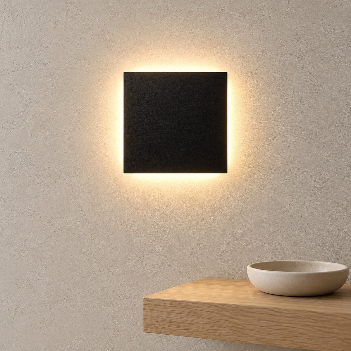 Mivorel black LED wall sconce glowing above an entryway shelf in daylight