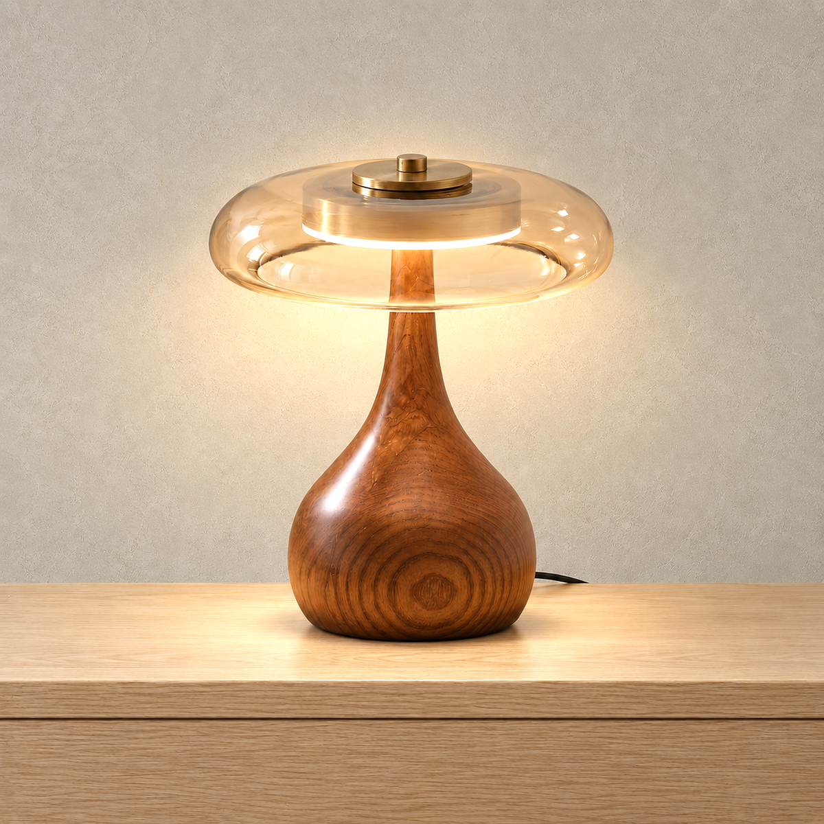Molirea table lamp in brown wood and amber, lit so the light shows through the amber glass shade