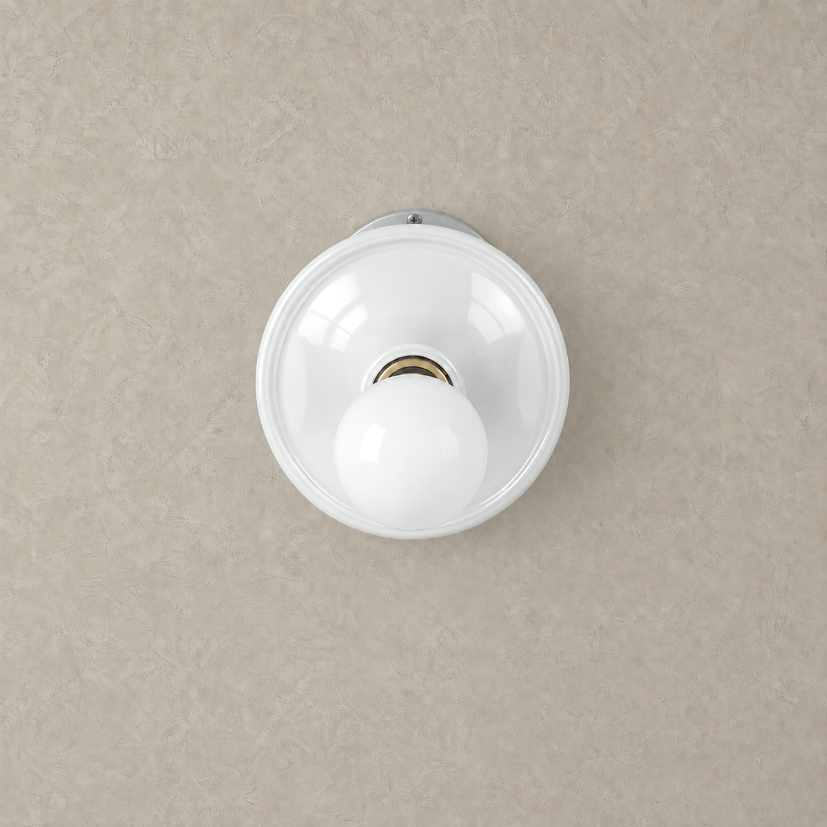 Monterla white wall lamp unlit against warm greige plaster with a round dish #color_white