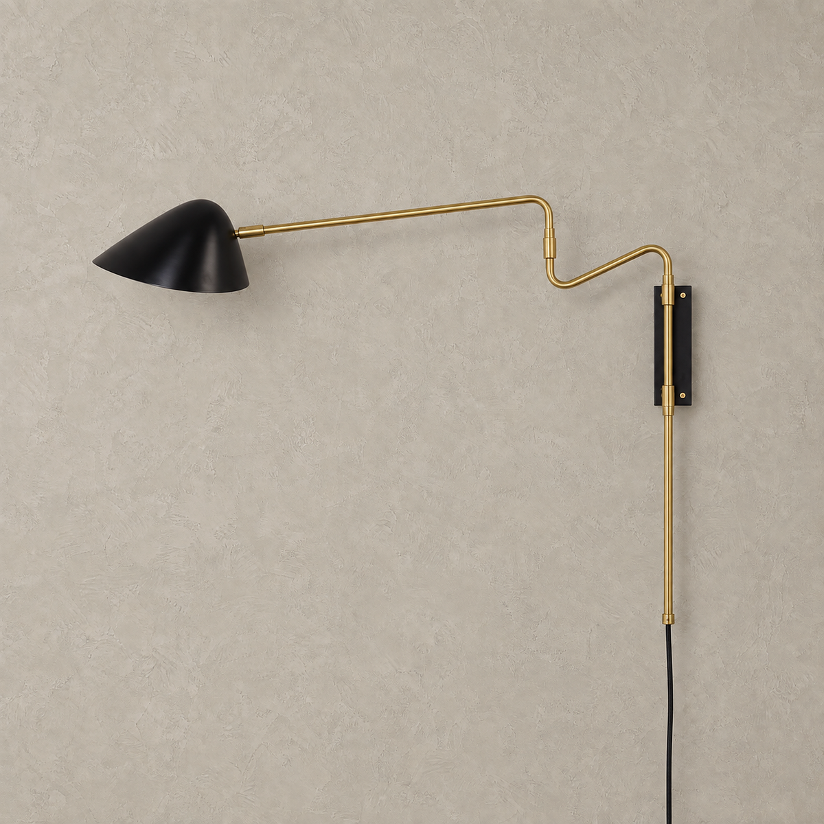 Movresa black swing arm wall sconce unlit on plaster with gold colored arm