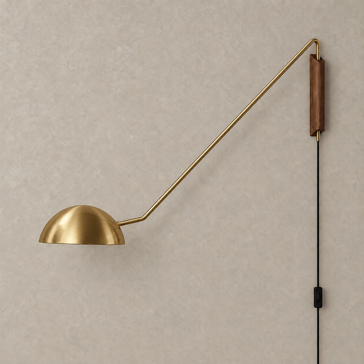 Nalesio gold plug in wall sconce shown unlit against greige plaster with its metal dome shade #color_gold