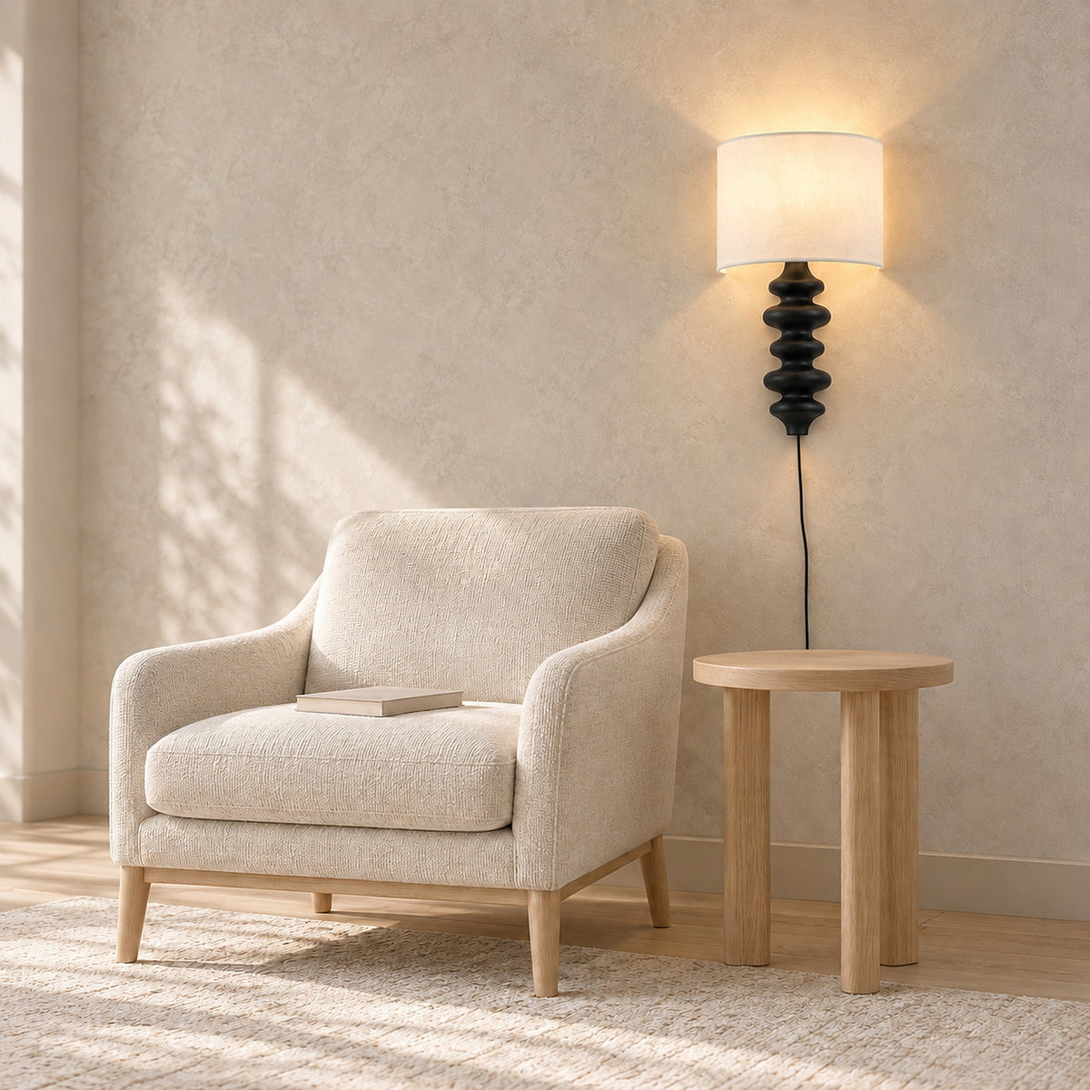 Nalimor black wall lamp lit beside an armchair in a study during the day