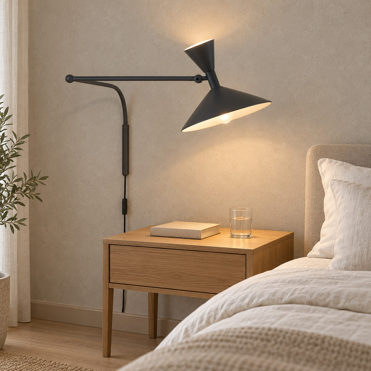 Nalveto black plug in wall lamp lit above an uncluttered guest bedroom nightstand #color_black