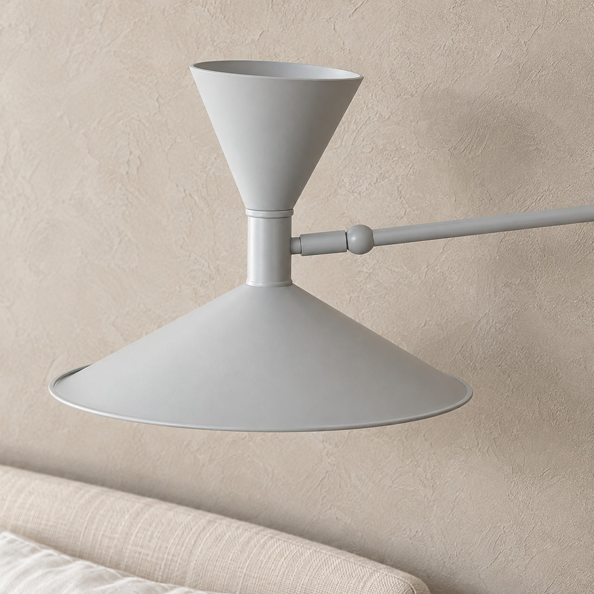 Nalveto white wall sconce close up showing the metal cones and head joint in daylight