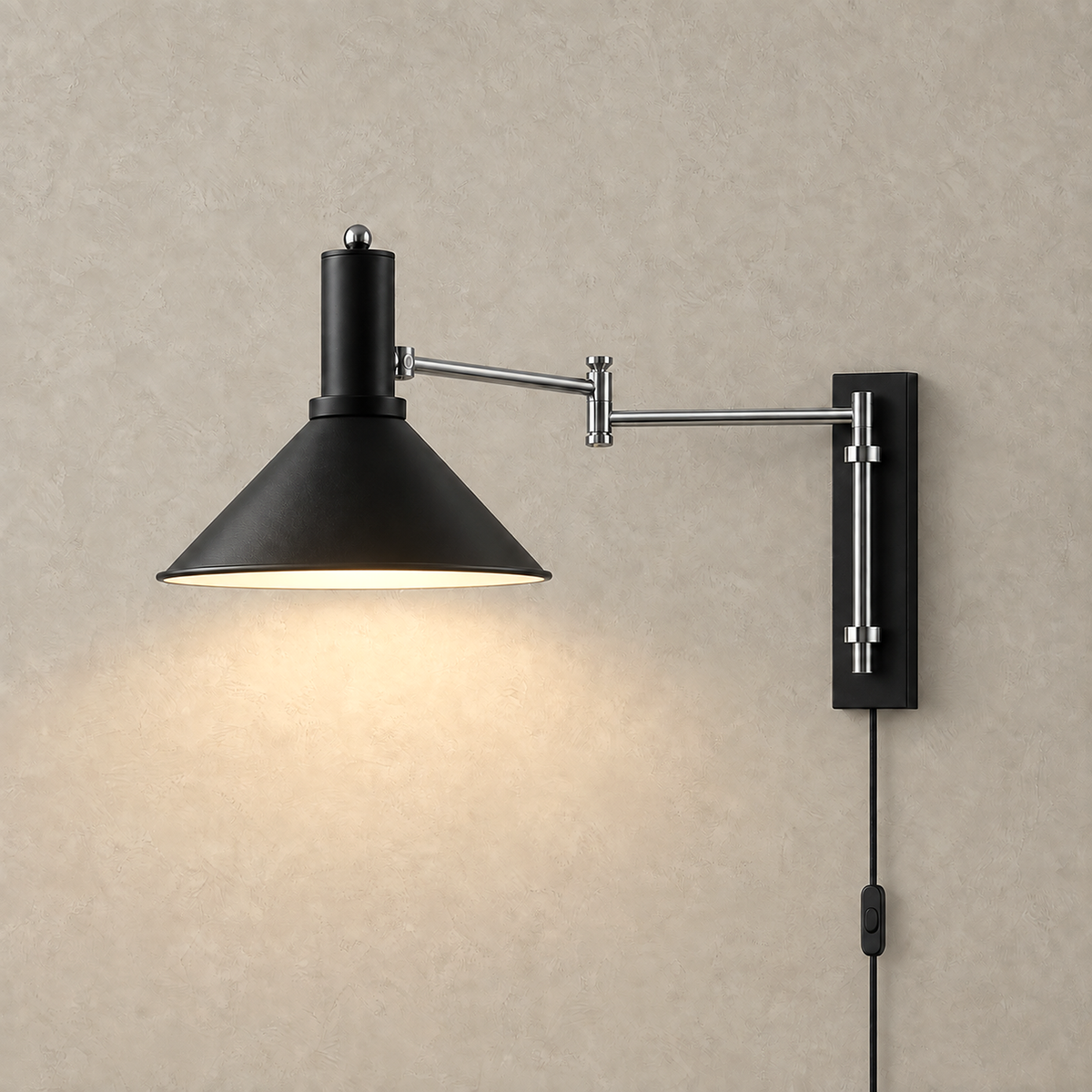 Navellir matte black wall sconce lit against a warm plaster wall showing its cone shade
