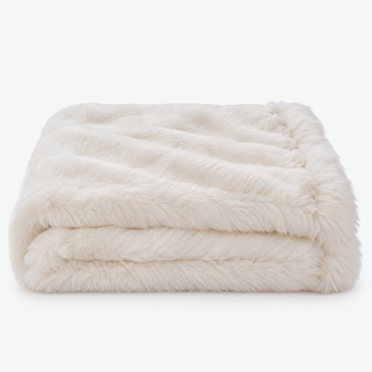 Navorel white faux fur throw blanket laid in loose folds with its shaggy long pile surface on show