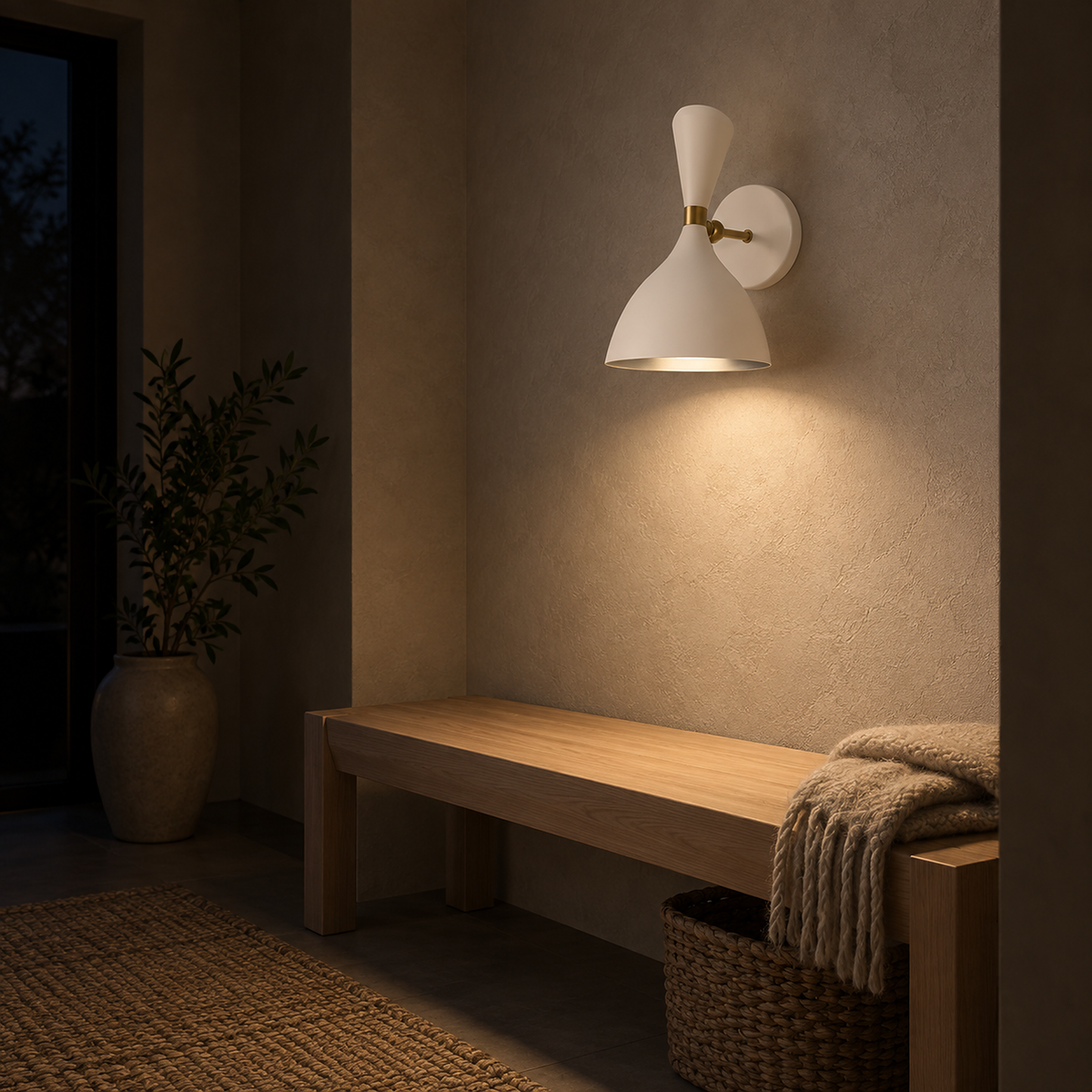Nematore white wall lamp casting warm light above an entry bench at night