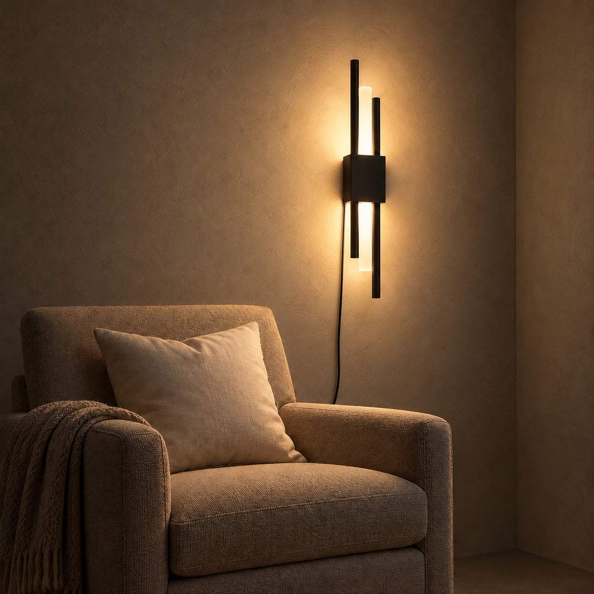 Nemirsa black wall light spreading a warm glow beside seating in a reading alcove at night