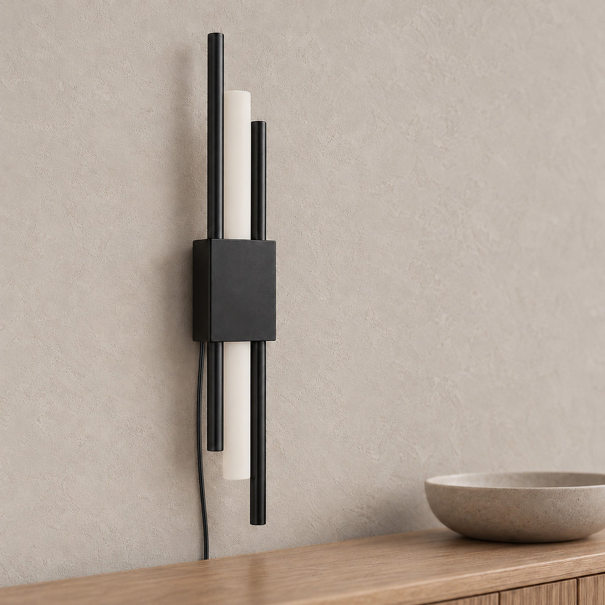 Nemirsa black wall sconce close up of the housing and a pale tubular section in an entryway