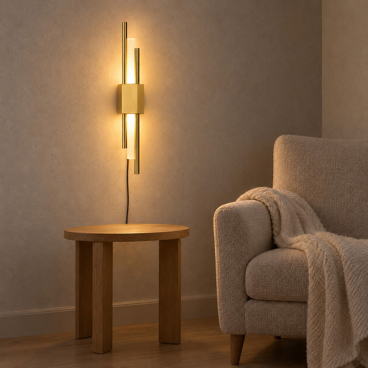 Nemirsa gold plug in wall lamp casting a warm glow beside an armchair in a reading alcove #color_gold