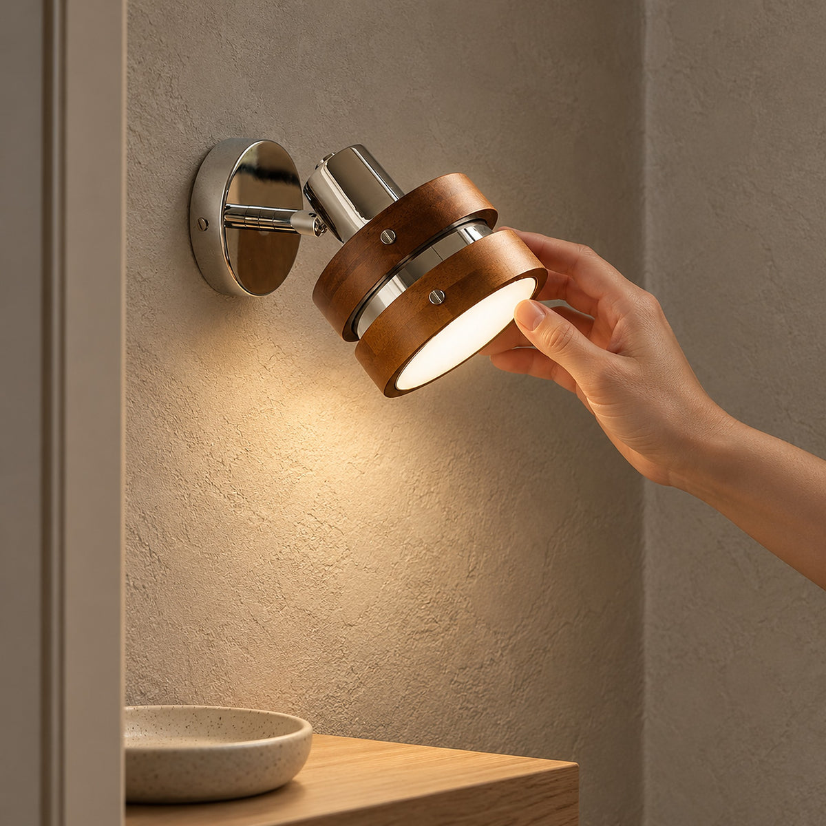 Nerilvo chrome and walnut wall light with a small round backplate on an entryway wall