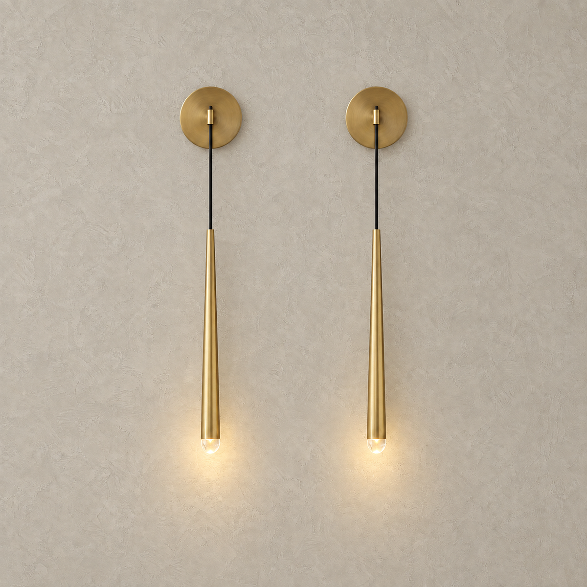 Nerisavo polished brass hanging wall sconce set of 2 lit side by side on a plain backdrop