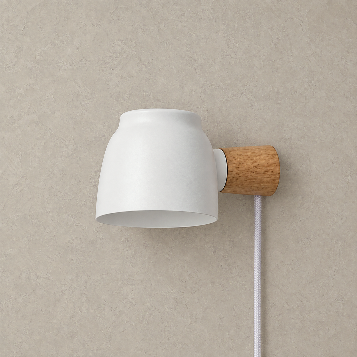 Netirama white plug in led wall sconce unlit on a plain plaster wall with iron shade and aluminum body