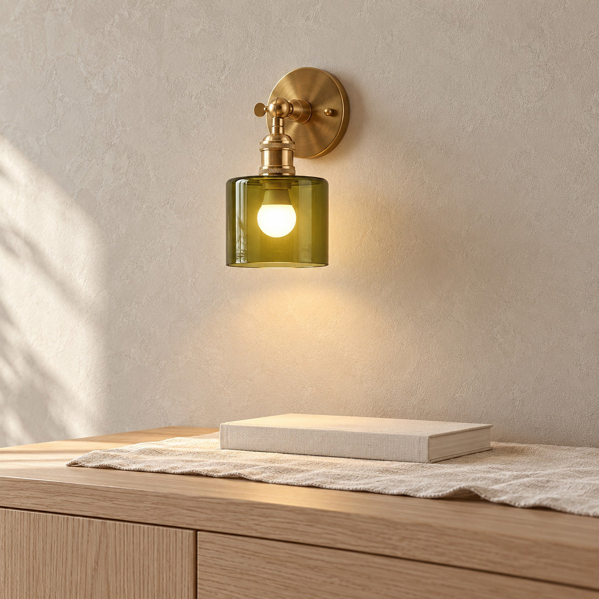 Nevalto olive wireless wall light glowing above a sideboard in a dining room by day #color_olive