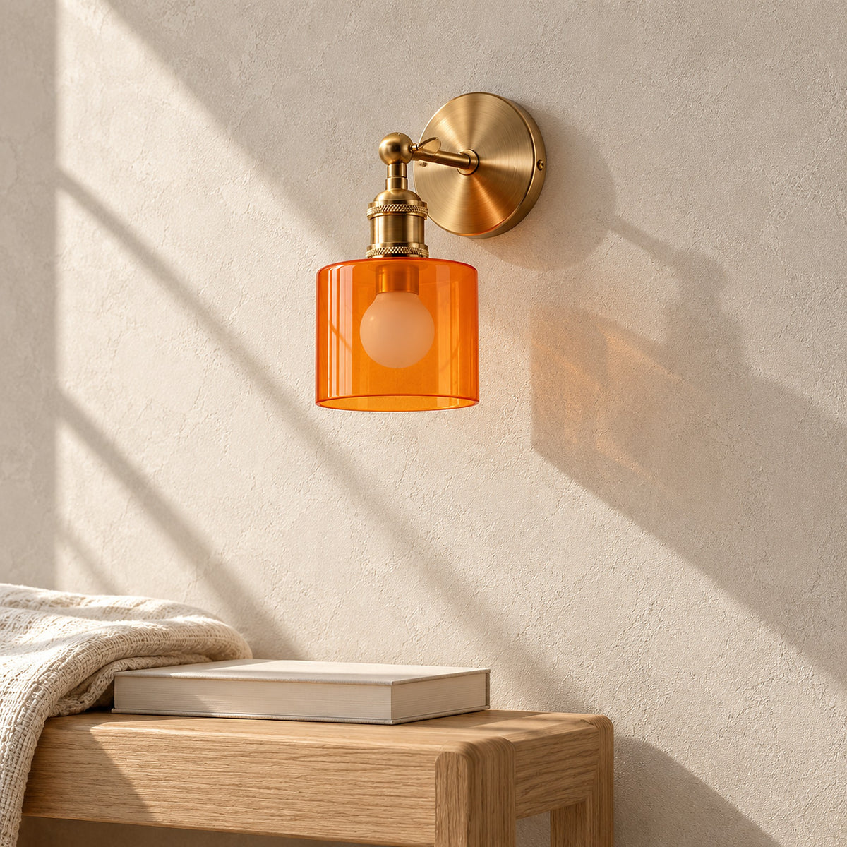 Nevalto orange wall light unlit on a sunny hallway wall, glass shade and round backplate