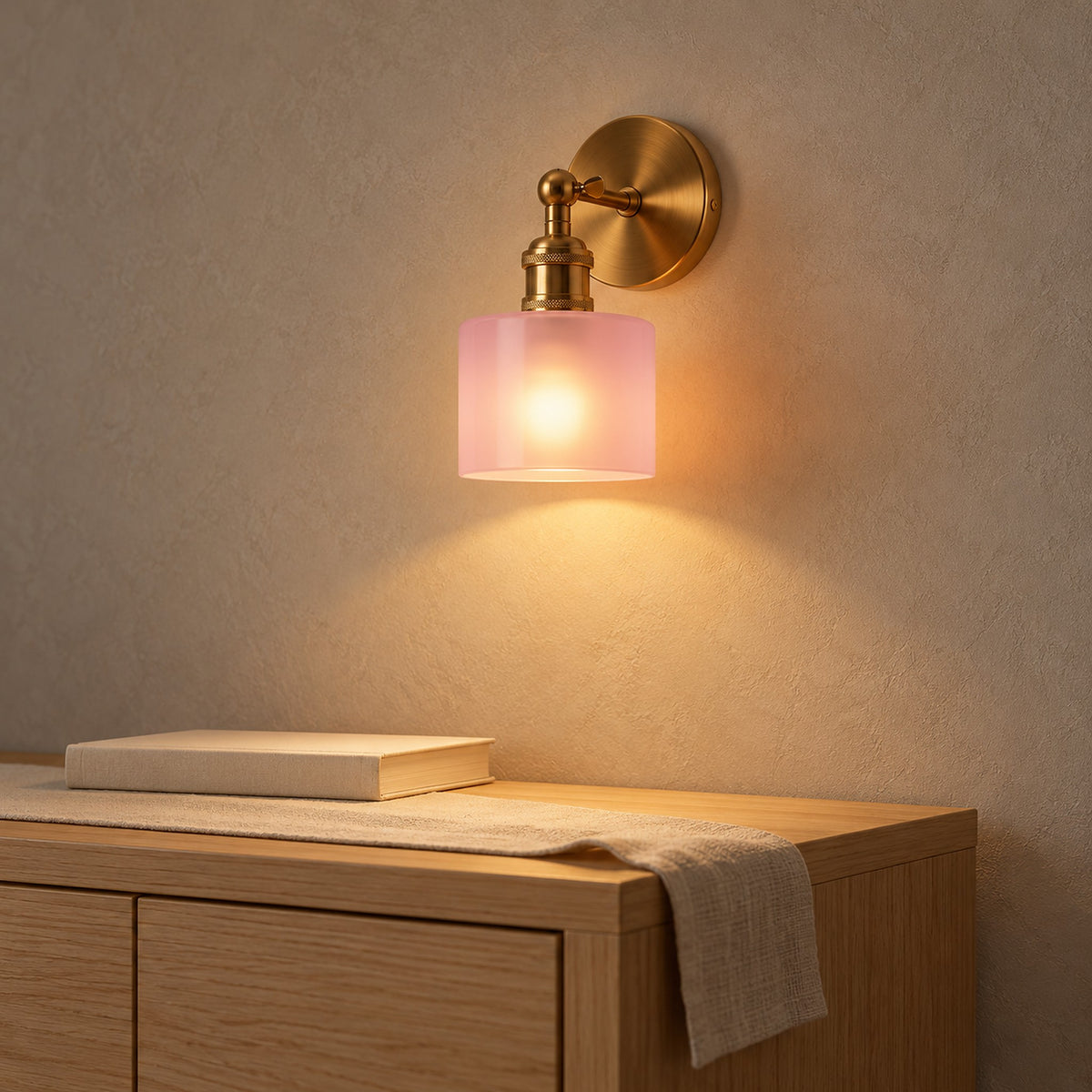 Nevalto pink wall sconce casting a warm downward glow in a dining room #color_pink