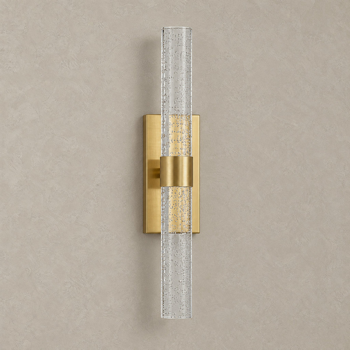 Nimarlo gold rechargeable wall sconce unlit on a plain plaster wall, clear acrylic rod and rectangular backplate
