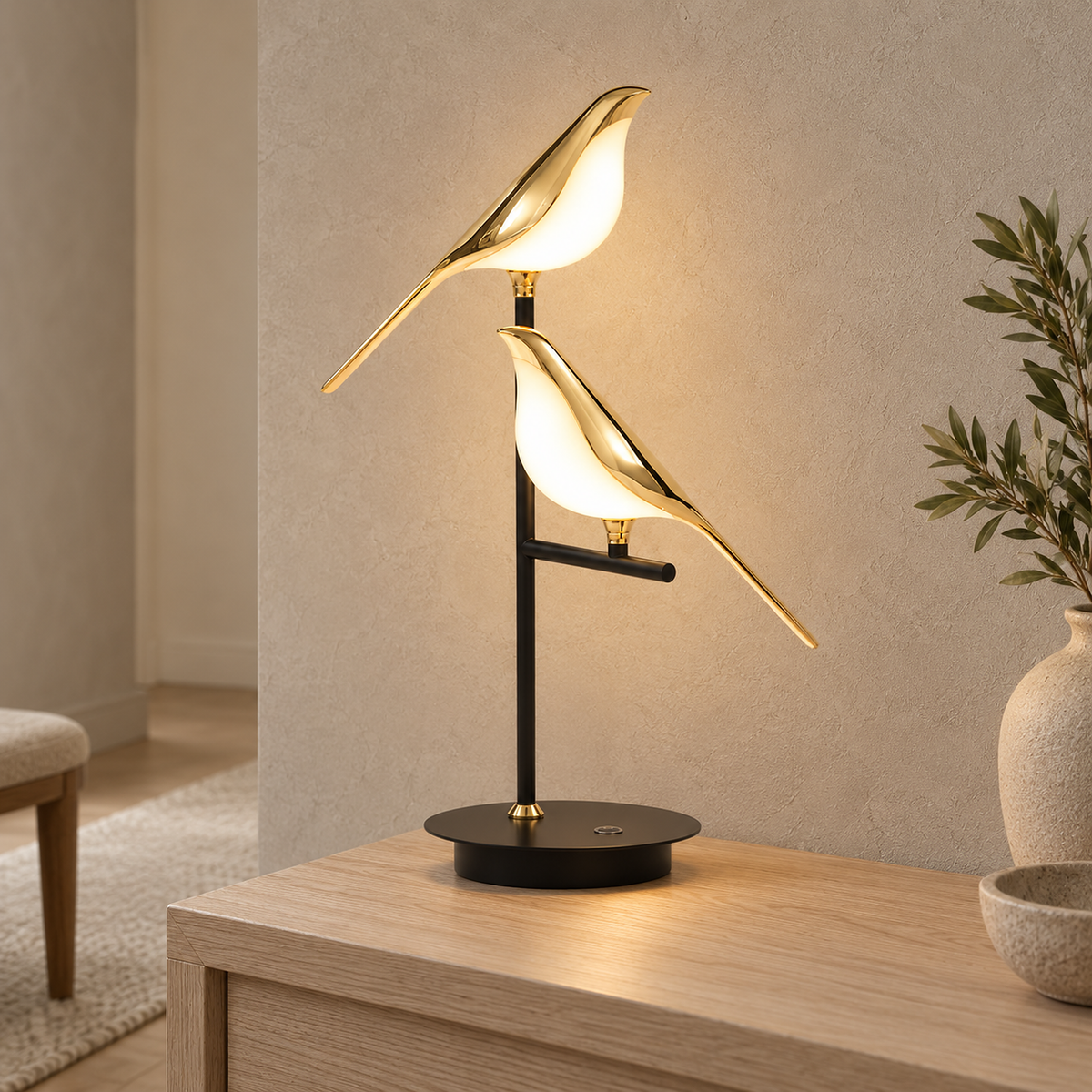 Nirelta black and gold two bird table lamp glowing on a hallway console in daylight
