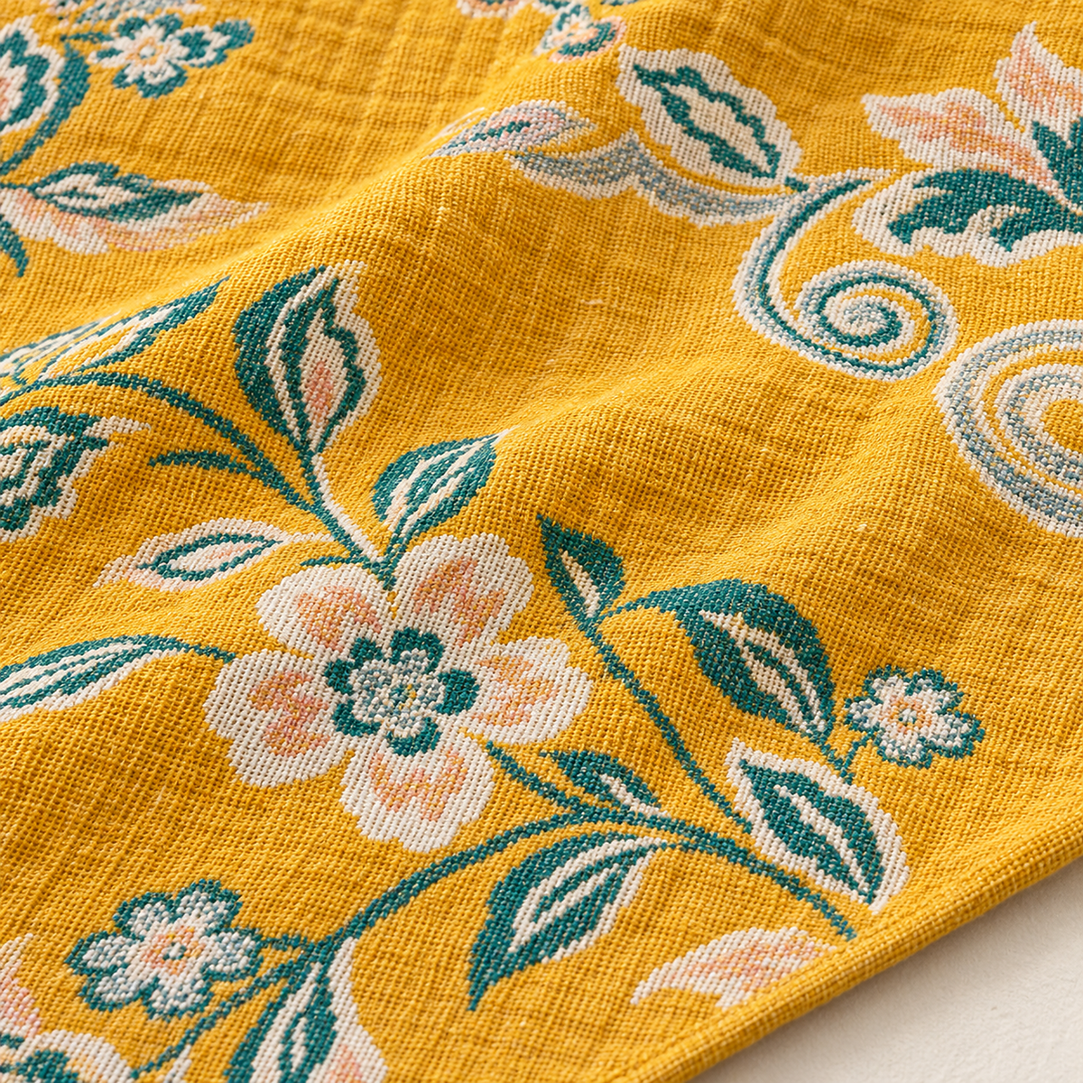 Nivarel yellow cotton muslin blanket in close detail, showing the threads of its yarn dyed pattern