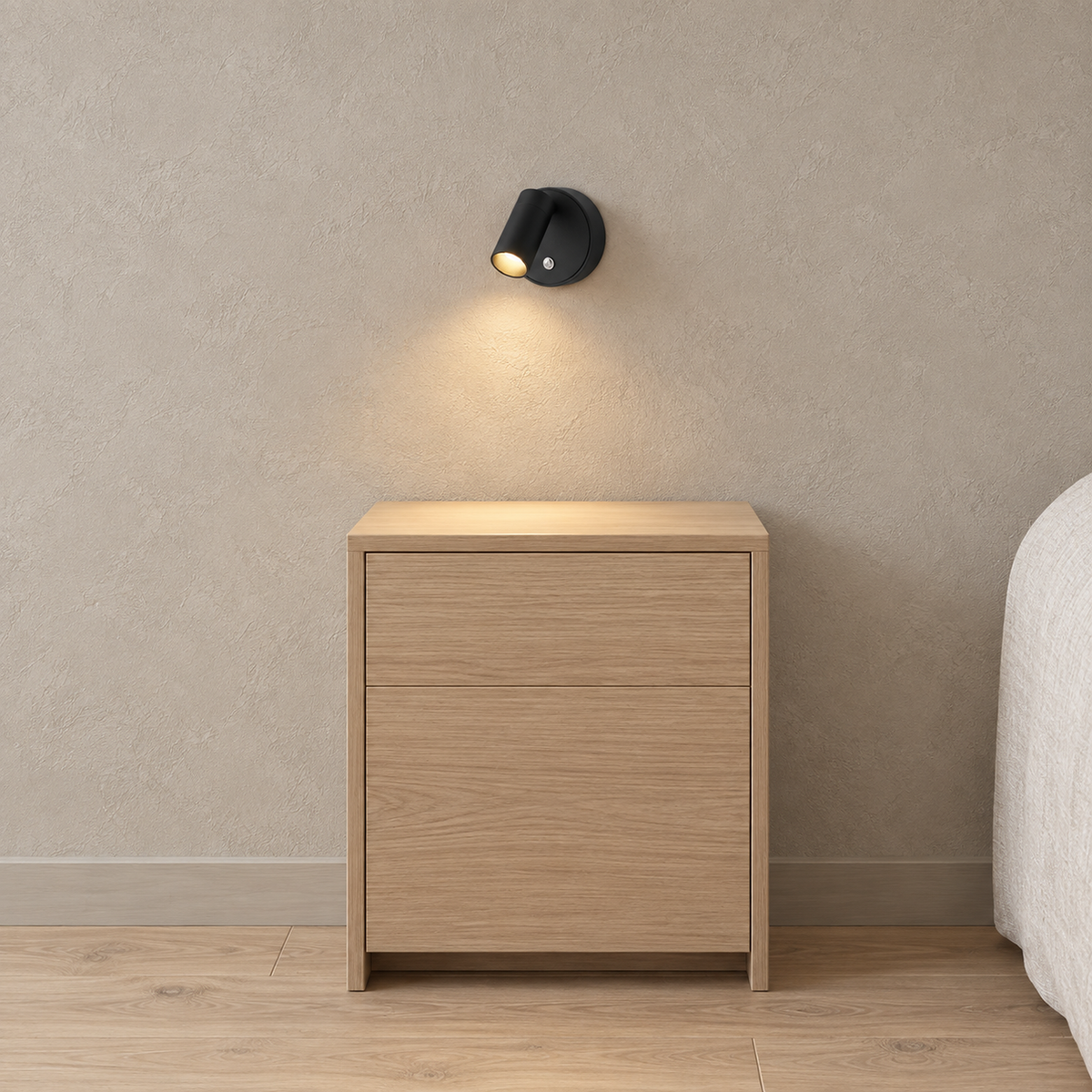 Nocarel black battery operated wall sconce showing its front control above a bedside cabinet