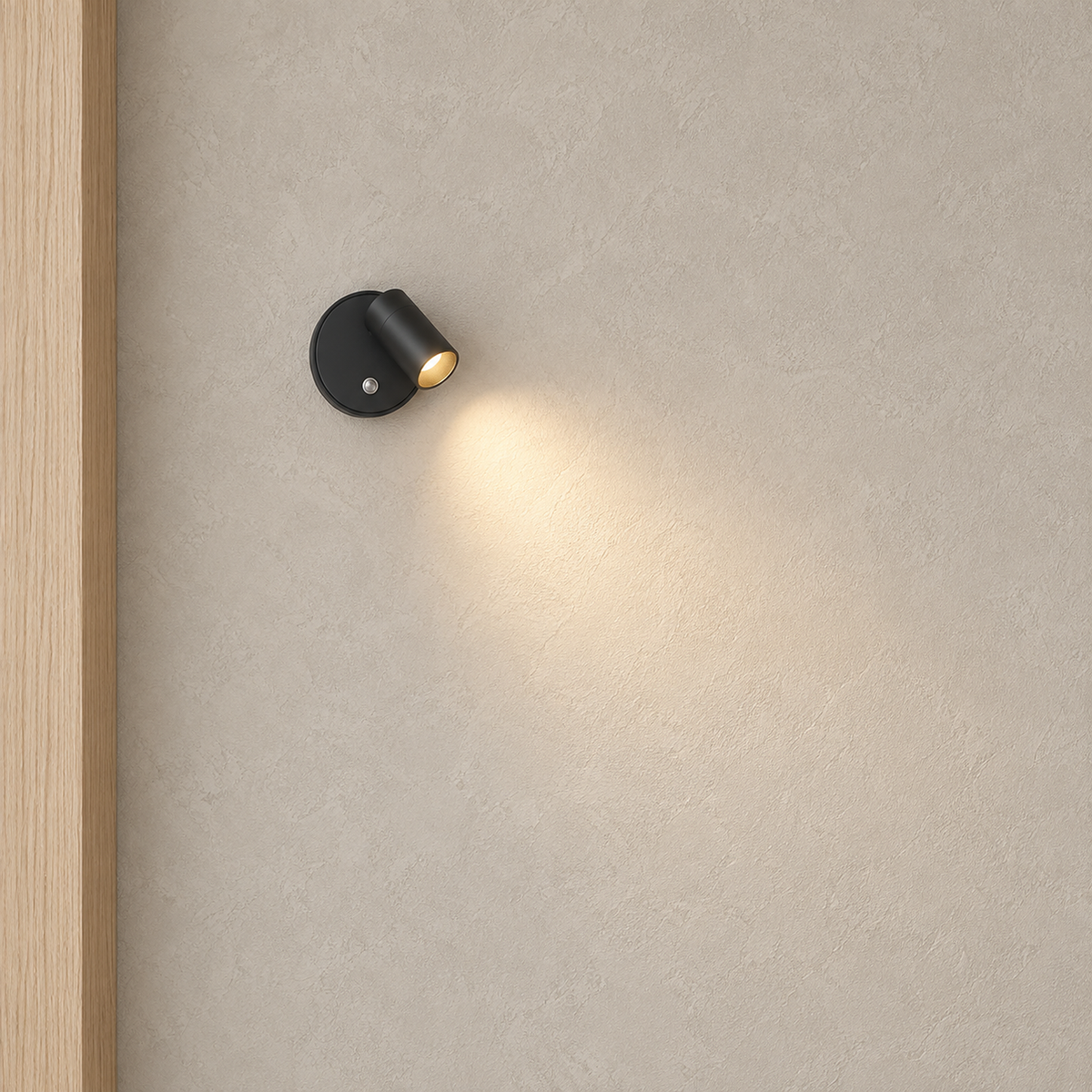 Nocarel black cordless wall lamp casting warm light across a clear hallway wall