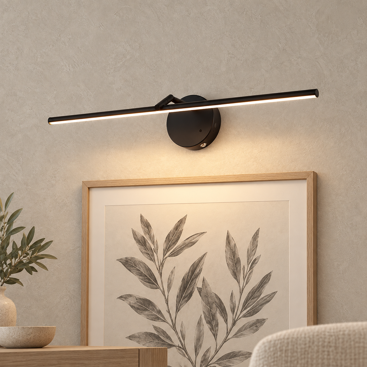 Nolesira black cordless wall lamp lighting a framed print on a dining room wall #color_black