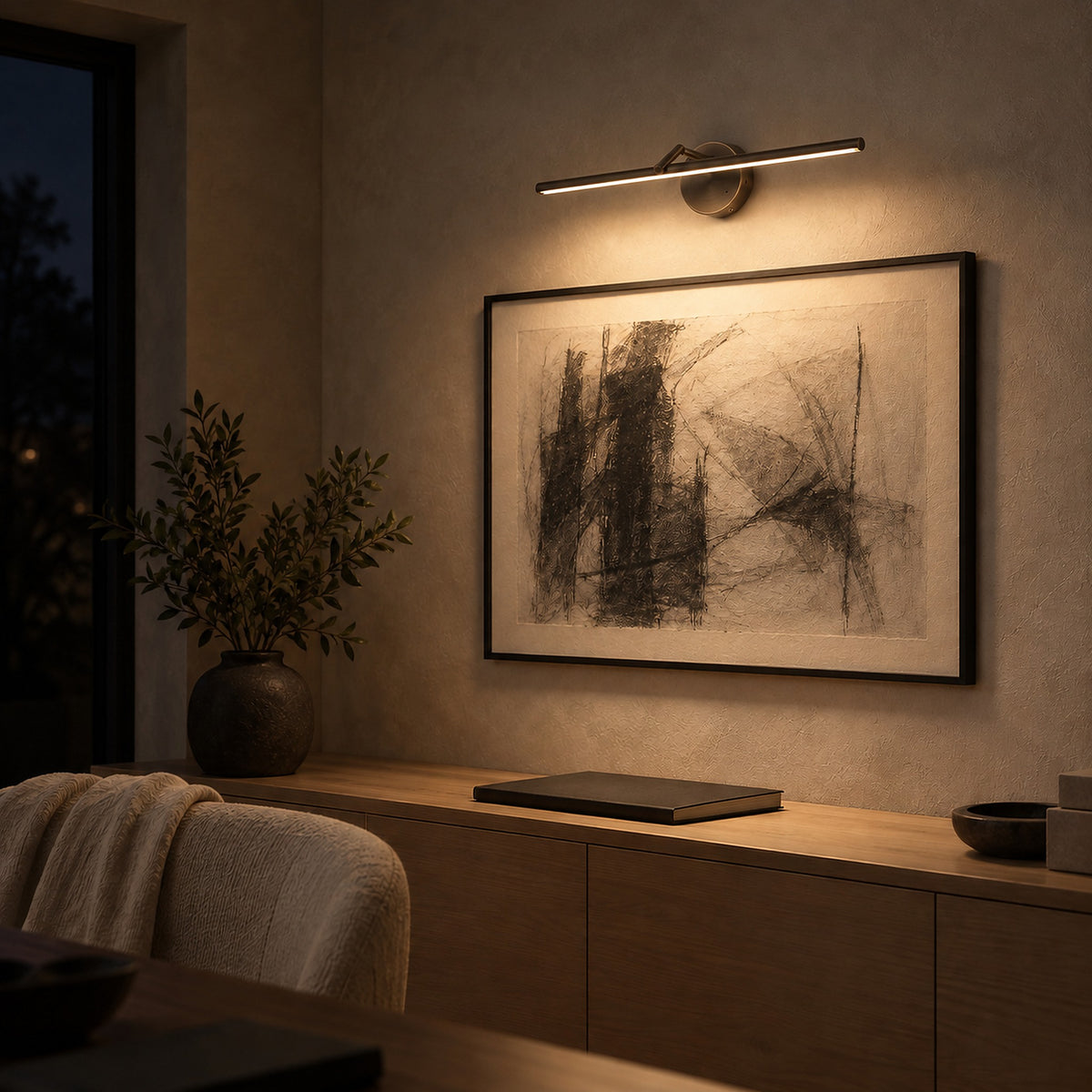 Nolesira bronze cordless wall lamp washing framed artwork in a study at night #color_bronze
