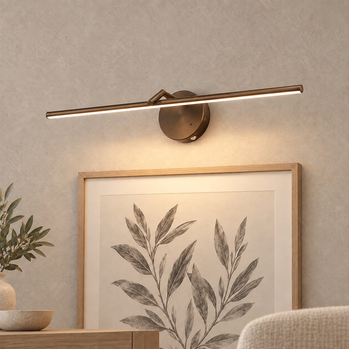 Nolesira bronze rechargeable wall sconce lighting a framed print on a dining room wall #color_bronze